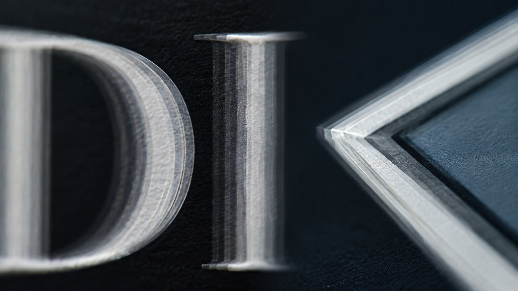 Macro still of thin letter edges and logo corners collapsing, illustrating why AI video text flickering hits type first